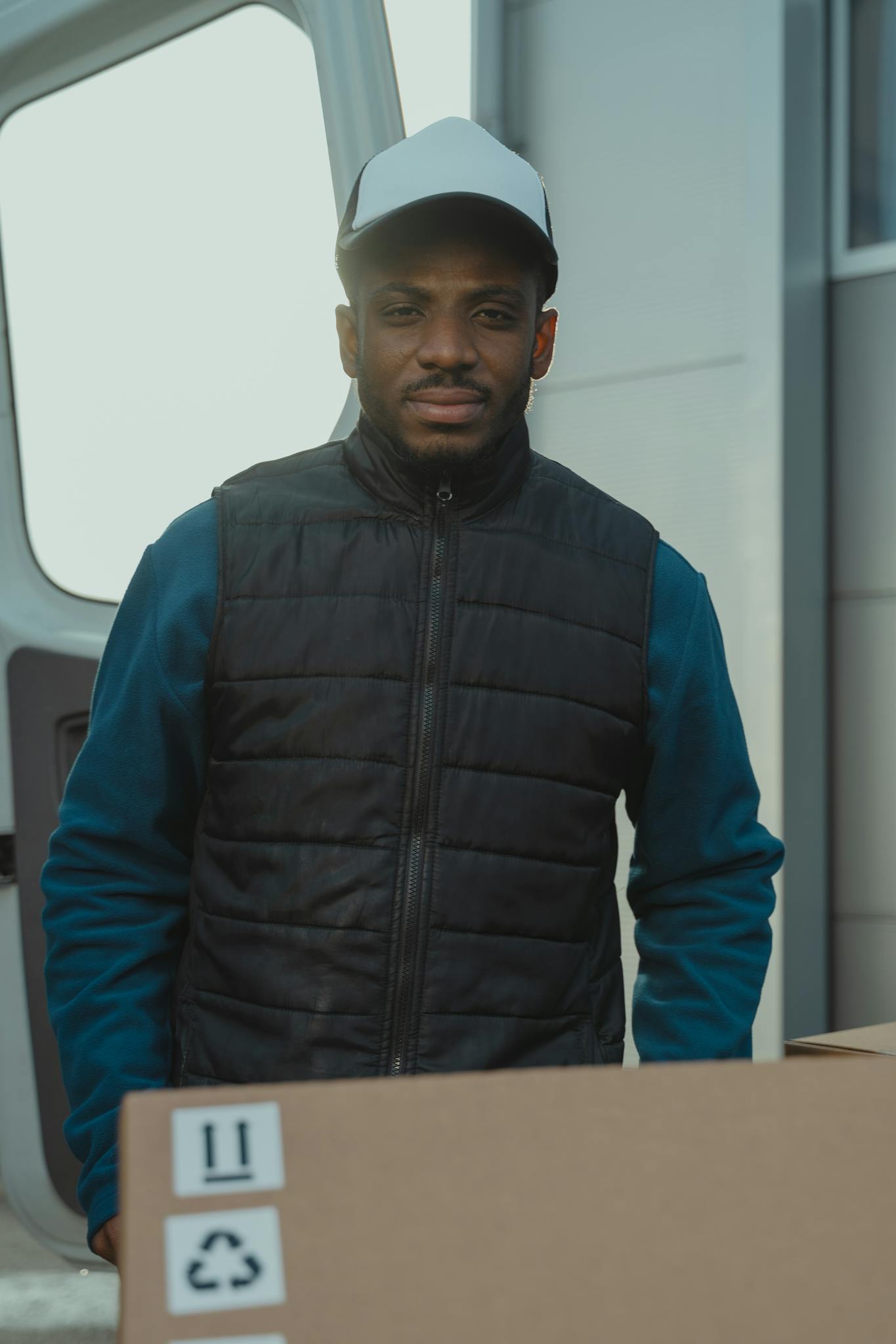 Courier delivering packages outdoors with a smile, showcasing efficient delivery service.